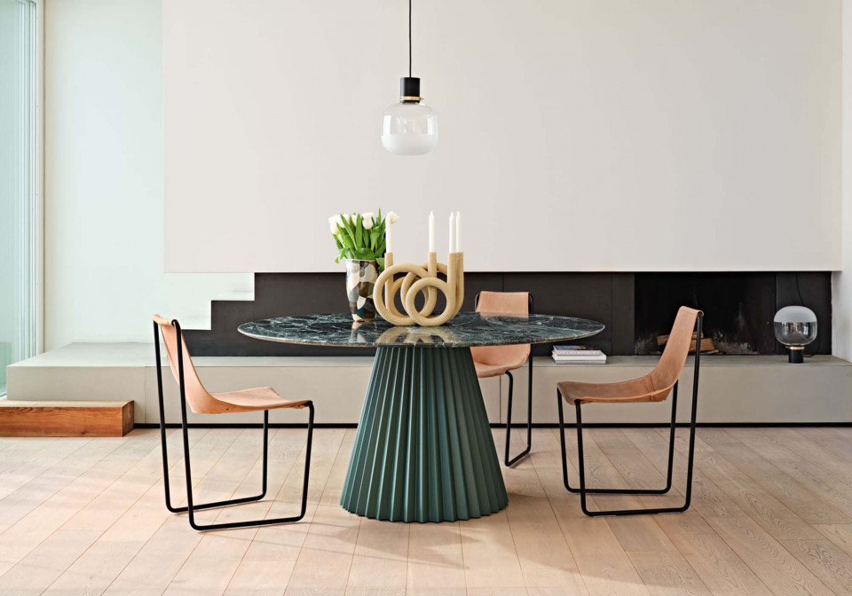 Plissé table design by Paola Navone with dark green base and green tinos marble top